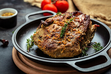 roasted pork loin. large piece of baked pork with mustard on pan. Festival food recipe background. Close up. top view