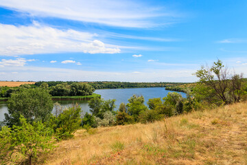 Obraz premium Summer landscape with beautiful river, green trees and blue sky