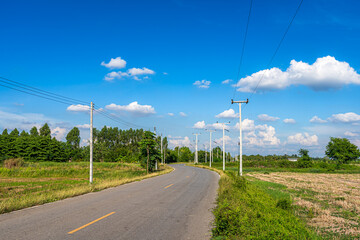 Fototapeta premium view of asphalt roads countryside Beside with spring nature and tree green in fluffy clouds blue sky daylight background.