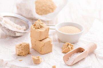 Fototapeta na wymiar Fresh and dried yeast with baking ingredients on white background