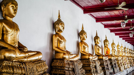 Many Buddha at gallery in Temple. Golden Buddha Statue.
