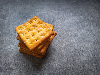 Stack of Sweet Crunchy Crackers isolated on abstract background.