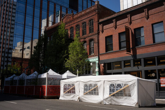 Portland, OR, USA - Apr 18, 2021: Outdoor Dining Tents Outside Of Portland Food Hall And Luc Lac Vietnamese Kitchen In Downtown Portland, Oregon, During A Pandemic Springtime.