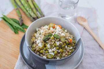healthy home made barley soup with spring vegetables, wild garlic and asparagus