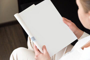 Hand holds white magazine with blank cover mock up. Hand in shirt hold clear magazine mockup template. A4 book softcover surface design.