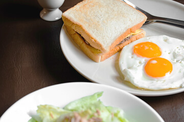 The Breakfast on the table are eggs and hamburger.