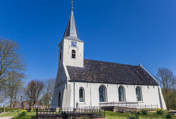 Fototapeta na wymiar Little white church in historic village Vierhuizen