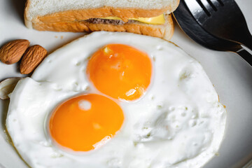 The Breakfast on the table are eggs and hamburger.