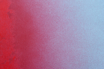 red spray paint on a blue colored paper background