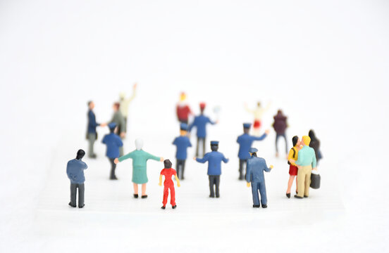 Top view group of miniature people in different colors costume, generation and career  stand on white background. Concept communication of society and social distancing. selective focus.