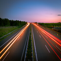 Fototapeta na wymiar Long exposure light trails on a hungarian countryside highway at dusk