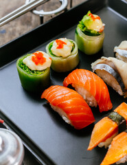 Sushi Set and sushi rolls served on wood table