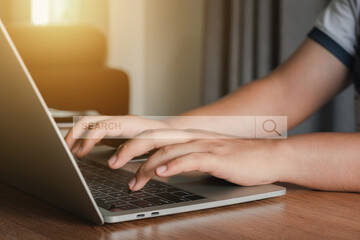 Hand businessman using laptop at home office workplace. Blank search bar webpage with browser of Internet data background. Searching on web search SEO engine network concept. Business technology .