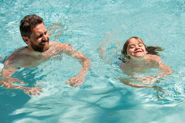 Father and son in pool. Summer weekend. Pool resort. Boy with dad swim in swimming pool. Active lifestyle. Fathers Day.