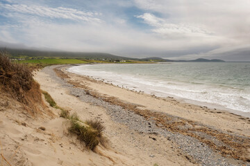 Small sandy beach, West coast of Ireland. Cloudy sky. Nobody, Irish nature landscape