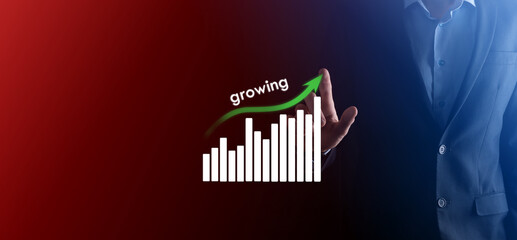 Business man holding holographic graphs and stock market statistics gain profits. Concept of growth planning and business strategy. Display of good economy form digital screen.