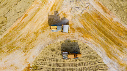 Aerial view on two rollers as compacting fraction and sand over construction site for new traffic...