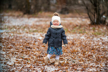 the child stands alone in the park