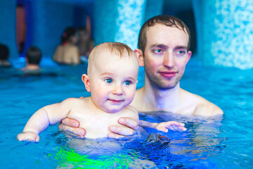Father with a baby in the pool
