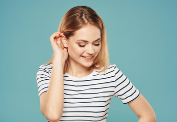 Portrait of beautiful woman in striped t-shirt blonde blue background smile