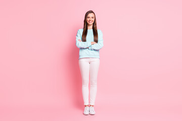Fototapeta na wymiar Full size photo of cheerful charming girl lovely smile crossed hands isolated on pastel pink color background