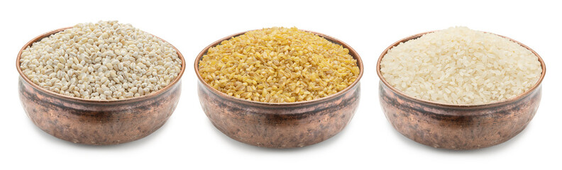 copper bowls with cereals isolated on white. Pearl barley, bulgur, rice.
