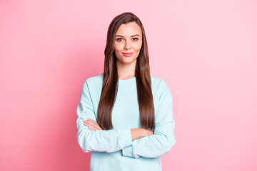 Photo of serious confident young woman folded hands wear blue sweater isolated on pastel pink color background