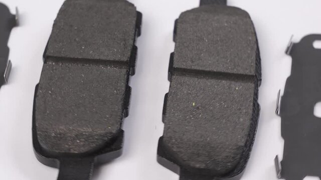 The brake pad rotates against a white background. part of the braking system.