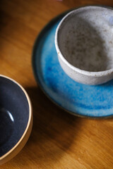 View of the blue earthenware. Clay cups on a table