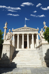 Beautiful neoclassic Academy of Athens public landmark building with beautiful spring clouds and deep blue sky, Athens historic centre, Attica, Greece