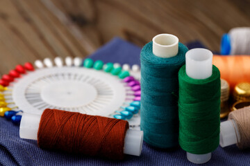 Threads and sewing accessories on brown wooden table