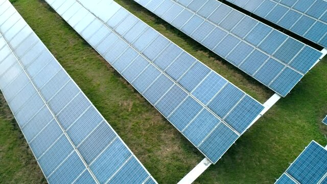 Aerial orbital view of Solar Panels Farm Solar Cell Station. Production of clean energy. Renewable green alternative energy concept.