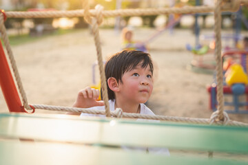 Asian child playing on playground
