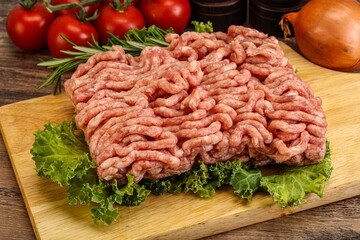 Raw pork minced meat over board