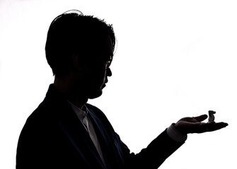 silhouette of businessman hold chess piece. concept of business strategy and marketing plan