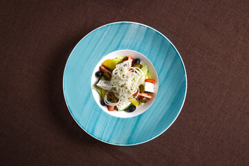 light salad with cheese, olives and vegetables top view