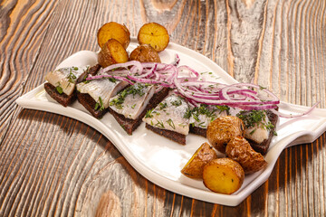 Herring snack with bread and potato