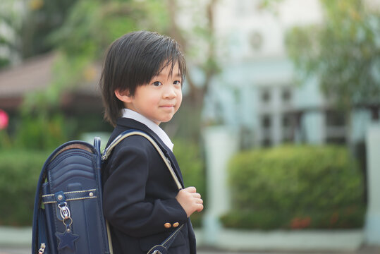 Asian student with backpack outdoors,back to school concept