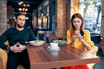 cheerful young couple sitting in a restaurant rest eating