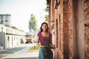 Obraz na płótnie Canvas Woman riding scooter on the street.