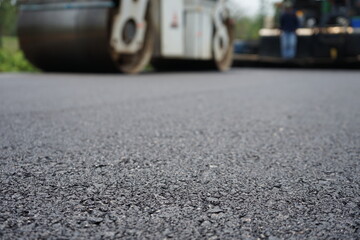 The image is blurred in the construction of asphalt road.