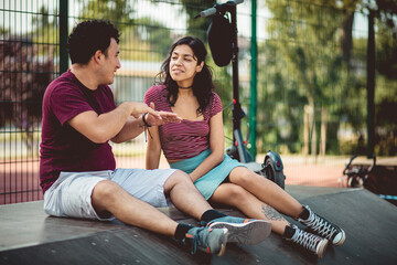 Young couple talking in the park.