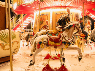 Seat horse on carousel illuminated at night