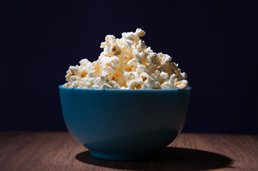 Bowl of popcorn on dark background front view copy space