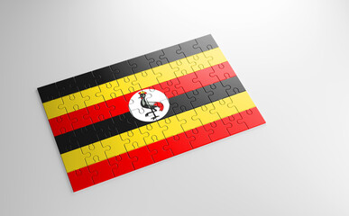 A jigsaw puzzle with a print of the flag of Uganda, pieces of the puzzle isolated on white background. Fulfillment and perfection concept. Symbol of national integrity. 3D illustration.