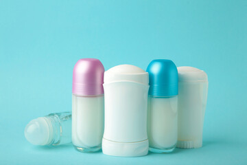 Different deodorants on blue background, top view. Skin care