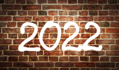 2022 year sign spray painted on the brick wall