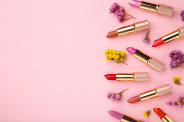 Lipstick with beautiful flowers on pink background with copy space