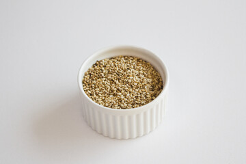 Natural sesame in a white bowl, raw seeds