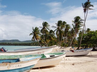 wooden fishing boats on a tropical beach